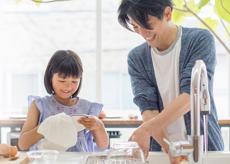 Dad and daughter washing dishes