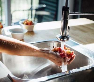 washing grapes at the kitchen sink