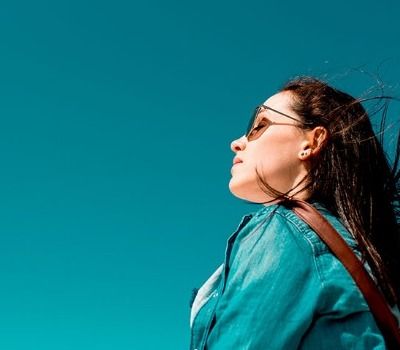 Girl with sunglasses in blowing wind
