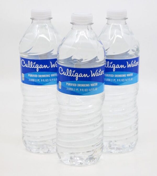 Three clear plastic bottles of Culligan Purified Drinking Water with blue labels and white caps, arranged on a white background.