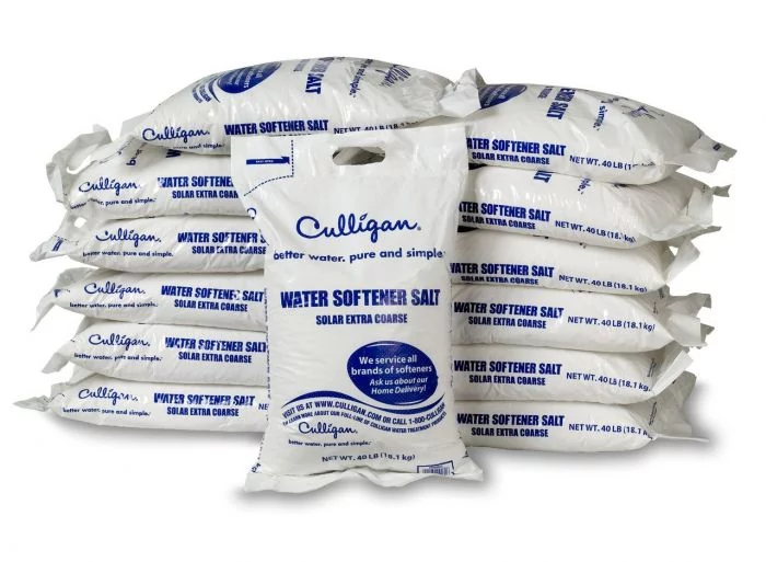 A large stack of white Culligan Water Softener Salt bags, each 40 lbs, with one bag standing upright in the foreground.