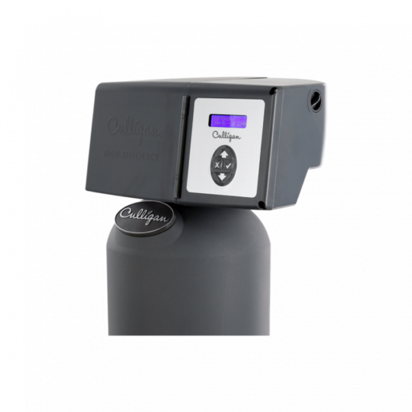 Close-up of a dark gray Culligan High-Efficiency water softener control head. It features a digital screen displaying 'SOFTENER TIME 12:00 AM' and a set of four control buttons: up arrow, down arrow, 'X', and a checkmark.