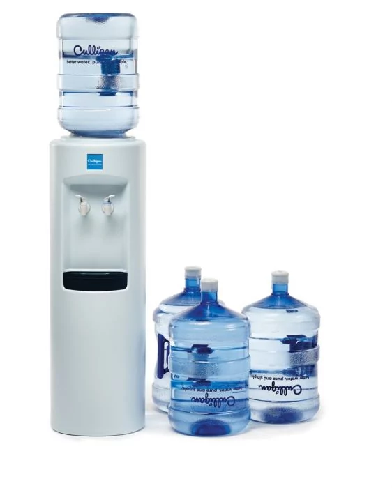 A light grey Culligan water cooler with a full blue water bottle on top, and three additional Culligan water bottles on the floor beside it, all against a white background.