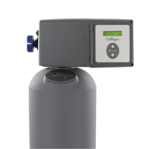 A gray Culligan High-Efficiency water softener with a digital display showing 'Softening' and 'APR-13-10 7:35P', control buttons, and a blue knob, set against a black background.
