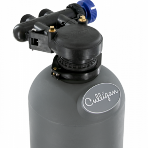 Top portion of a gray Culligan water treatment tank with a black control head and a blue adjustment knob, against a black background.