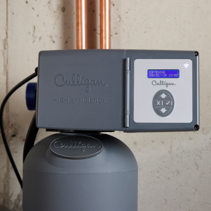 A gray Culligan high-efficiency water softener with a blue digital display showing 