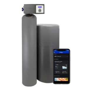 A gray Culligan High Efficiency water softener system, consisting of two cylindrical units, with a smartphone displaying the Culligan app's water usage data and system overview in the foreground.