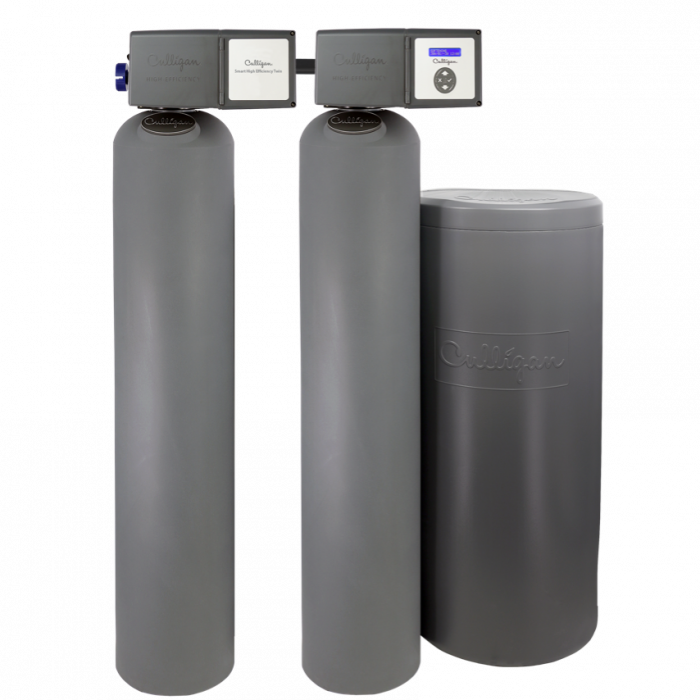 A Culligan Smart High Efficiency Twin water treatment system, featuring two tall grey tanks with control heads and a shorter, wider grey brine tank, all against a black background.