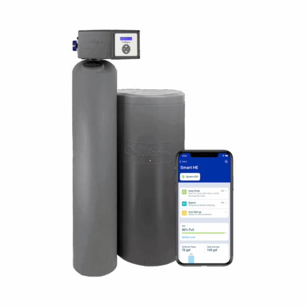 A gray Culligan Smart HE water softener system, consisting of a tall main tank with a digital control head and a shorter brine tank, positioned next to a smartphone displaying the 'Smart HE' app. The app shows 'System OK,' 'Salt 95% Full,' and water usage data.