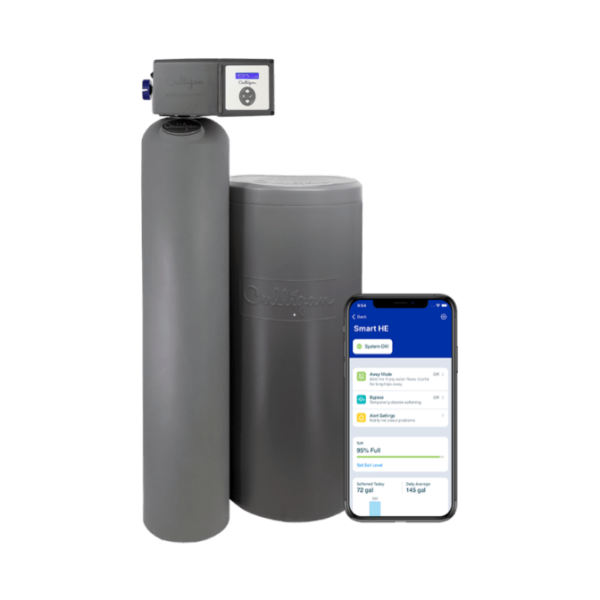 A Culligan Smart HE water treatment system, consisting of two gray cylindrical units, displayed next to a smartphone showing the 'Smart HE' app interface with 'System OK' status, salt level, and water usage data.